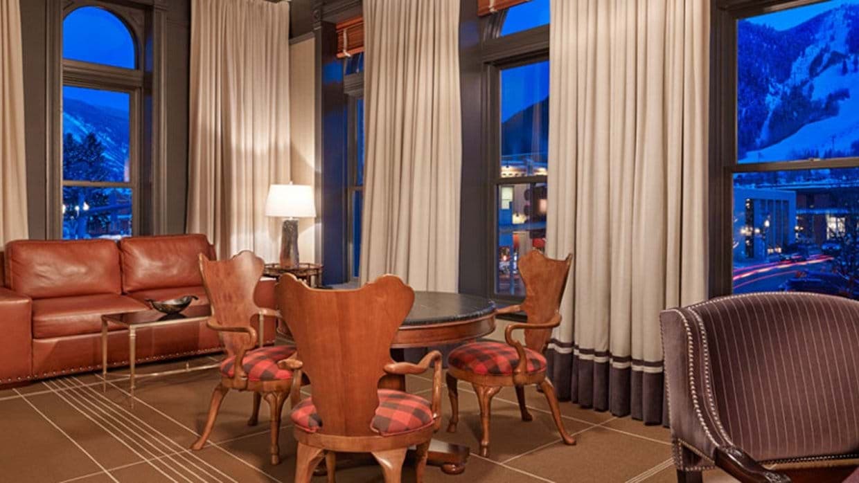 Sitting area with game table and views of illuminated ski slopes