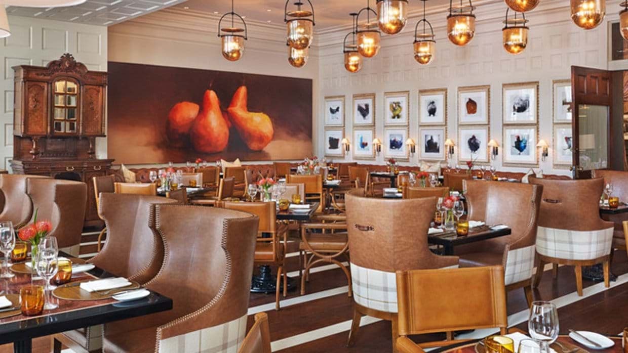 Dining room with wingback booth seating and local artwork