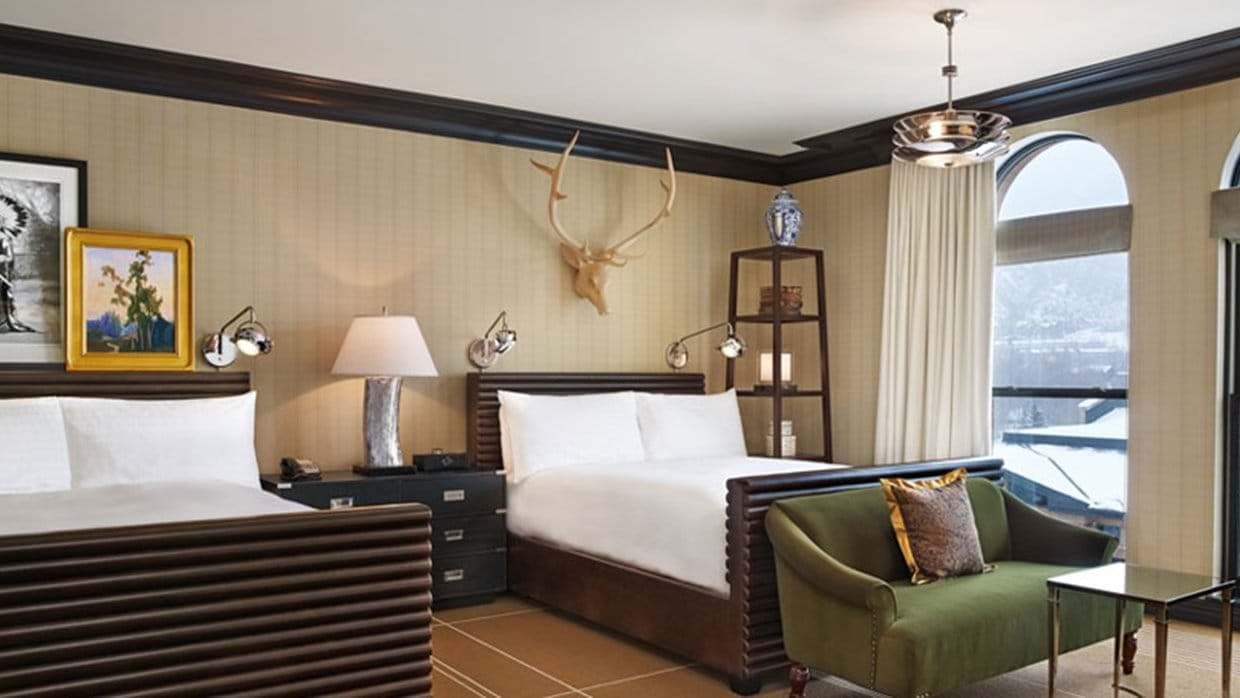 Guest bedroom with two queen beds and individual reading lights