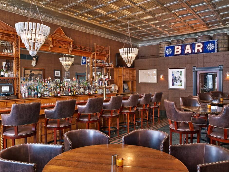 Lower level bar with leather seating and original tin ceiling