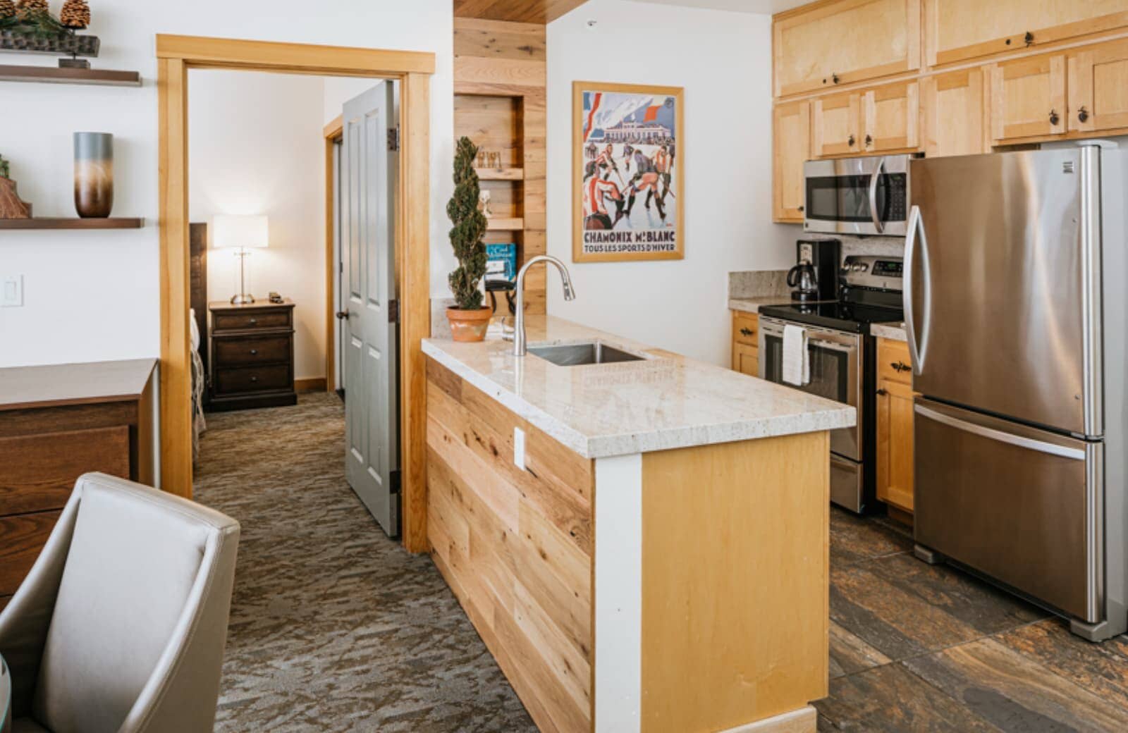 Kitchen with full-sized stainless appliances and stone-top island sink