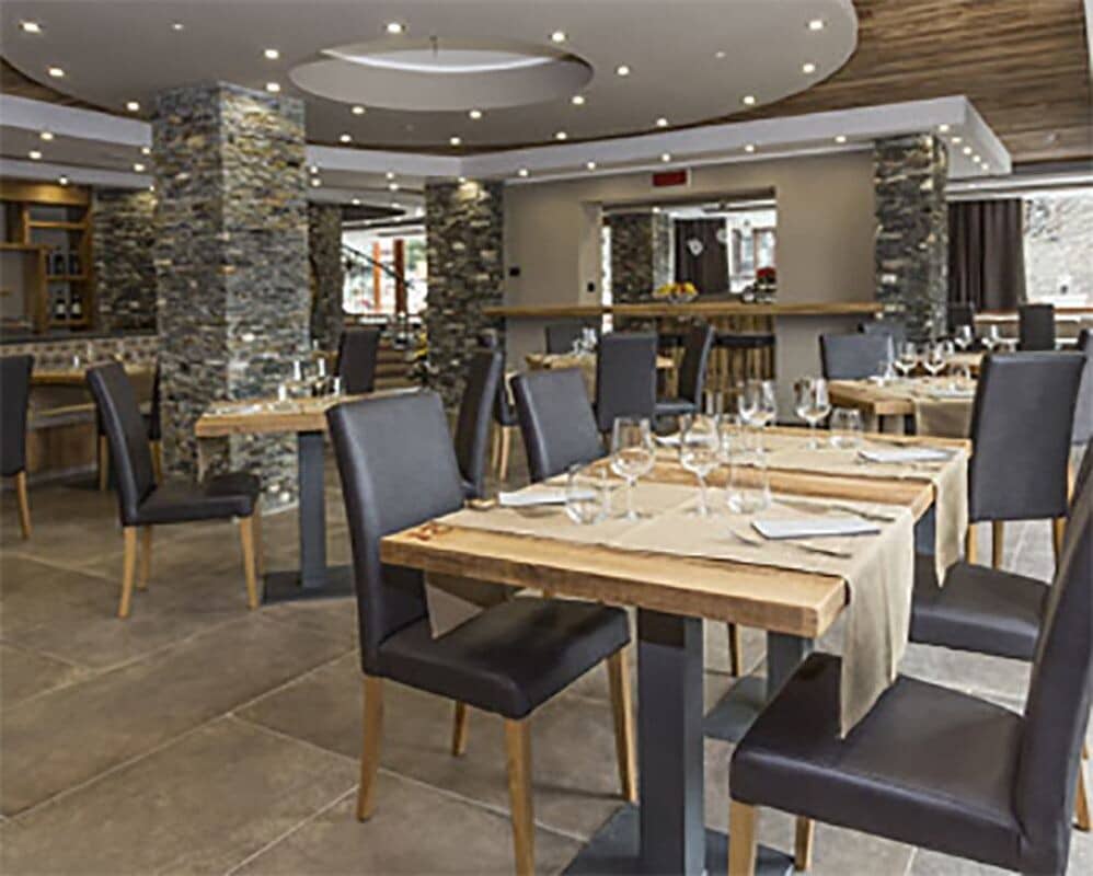 Dining area with stone pillars and circular recessed ceiling light