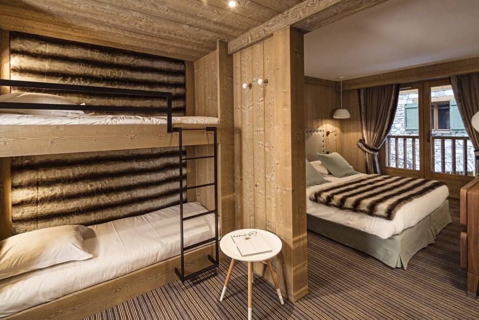 Family suite with twin bunk beds and adjacent queen bed