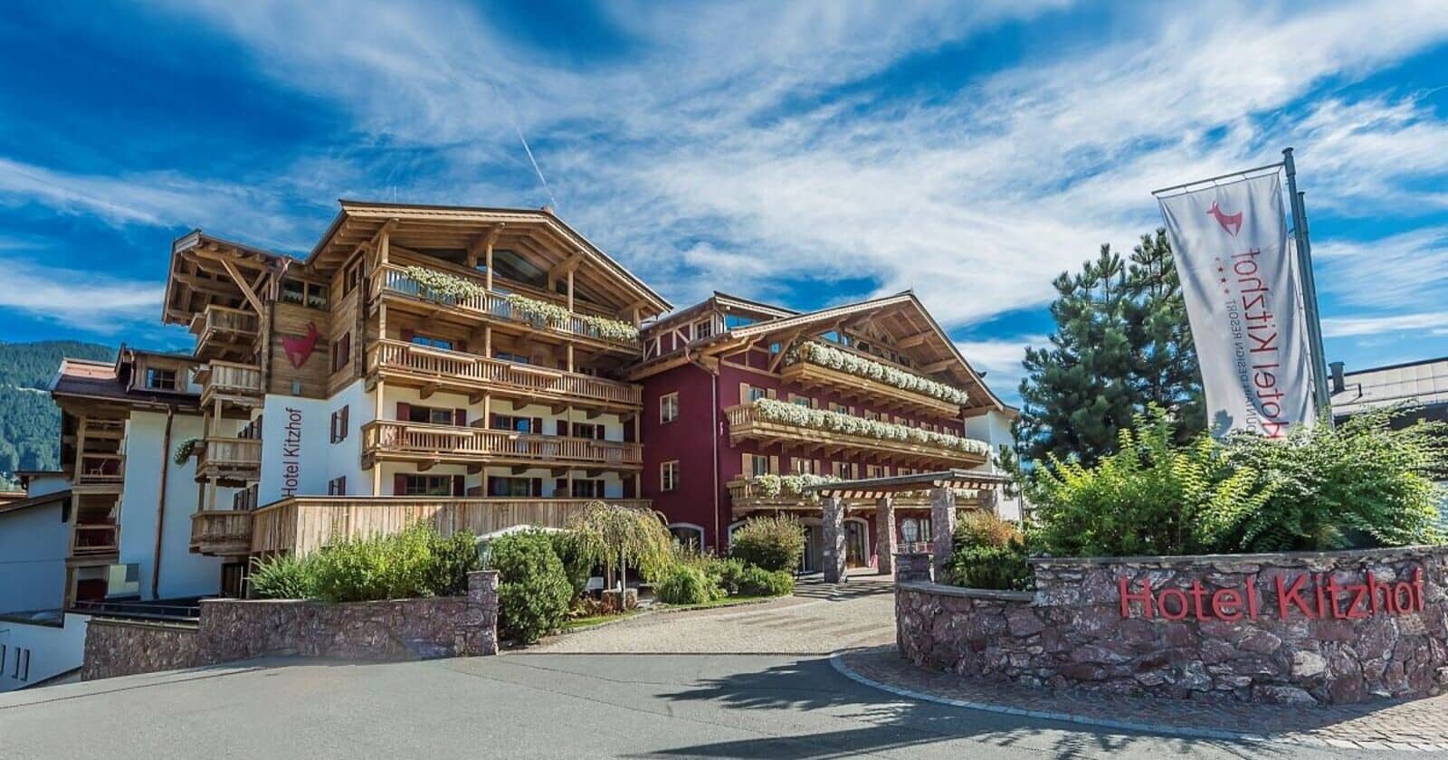 Hotel exterior featuring private balconies with flower boxes and timber architecture