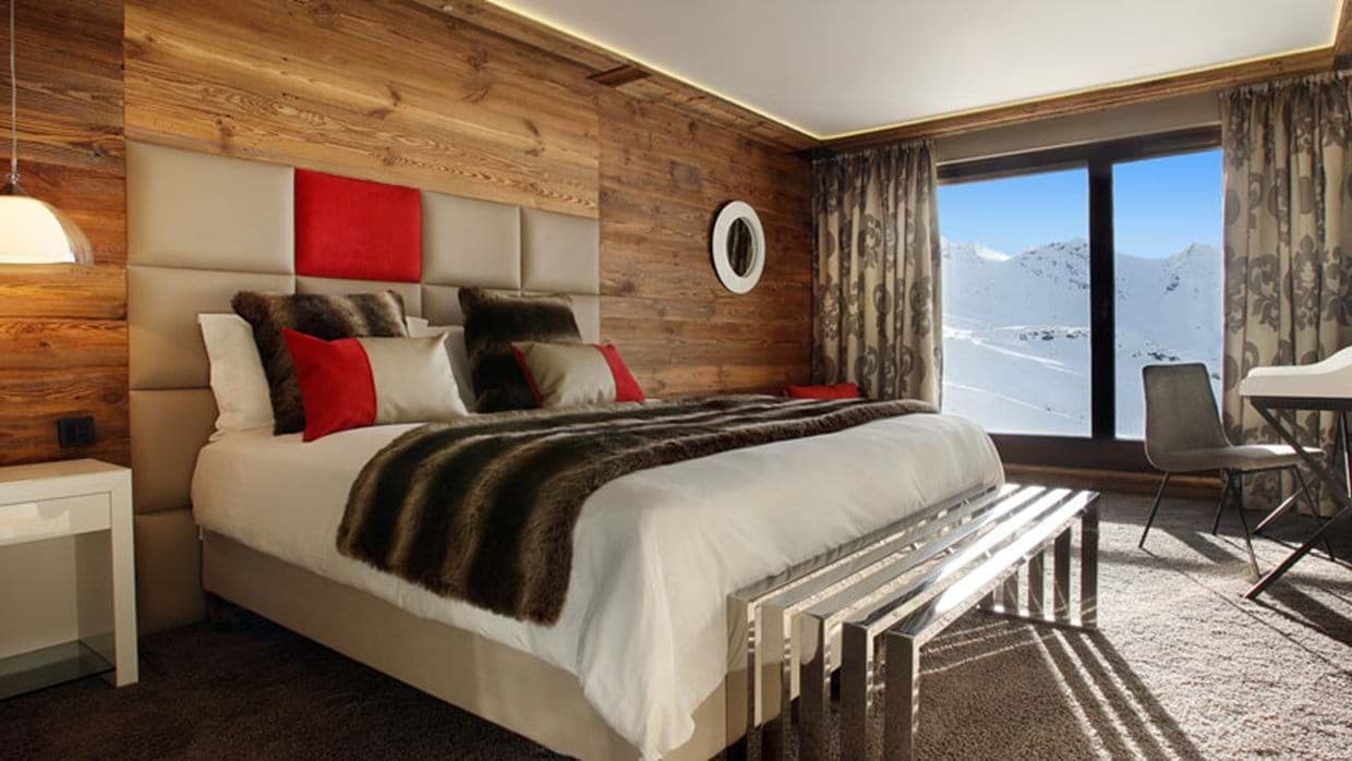 Primary bedroom with king bed and panoramic snow-capped mountain views