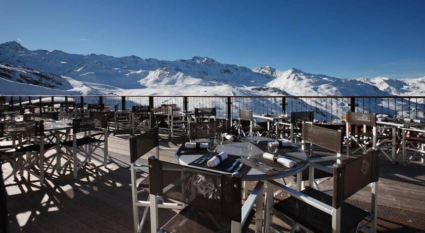 Outdoor dining terrace with mountain views and seating for 20+