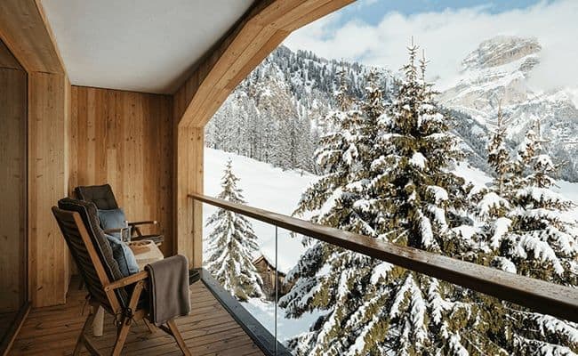 Private balcony with lounge seating and alpine mountain views