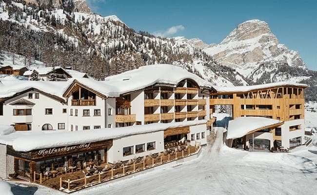 Ski-in/ski-out hotel exterior with outdoor terrace and mountain views