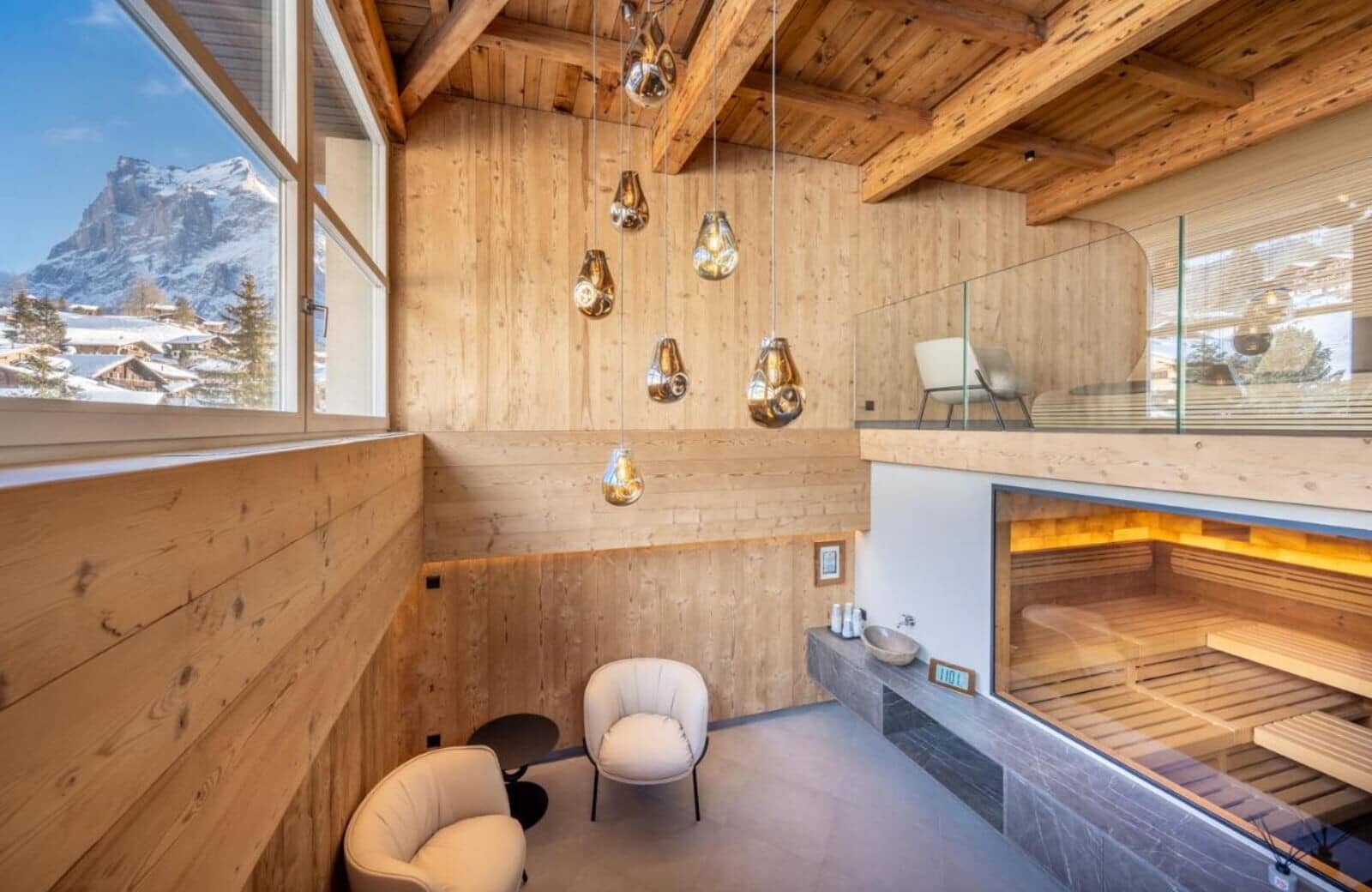 Spa lounge with private sauna and mountain views