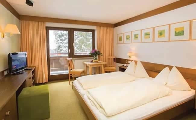 Guest bedroom with twin-to-king convertible bed and private balcony access