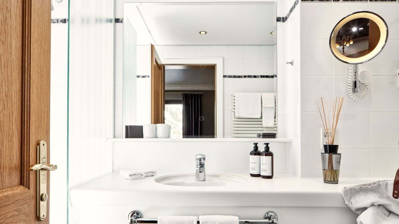 Bathroom vanity with heated towel rack and lighted makeup mirror