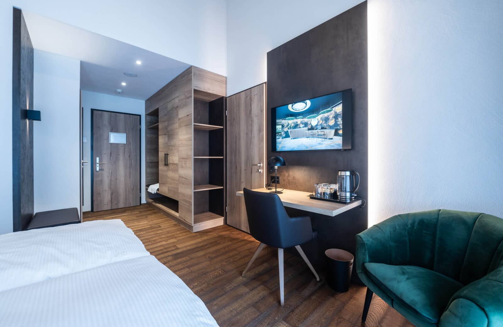 Guest bedroom with built-in wardrobe, workspace, and smart TV