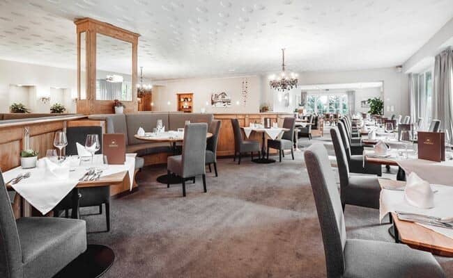 Dining room with banquet booth seating and multiple tables for large groups