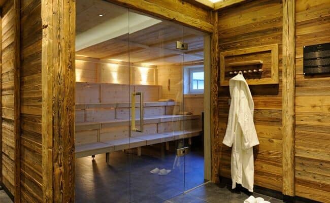 Private cedar sauna with tiered seating and glass entrance