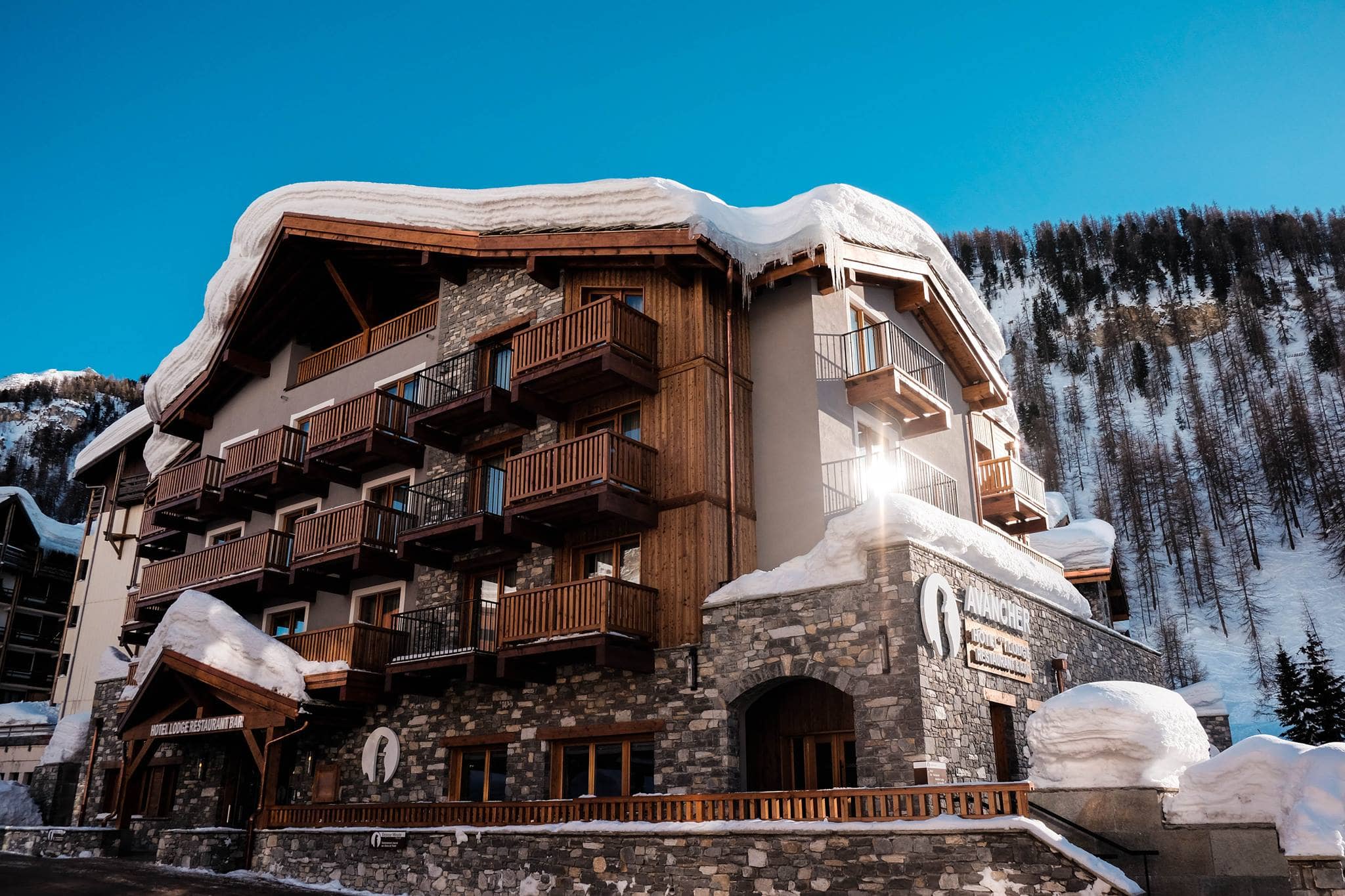 Stone and wood lodge with private balconies and mountain views