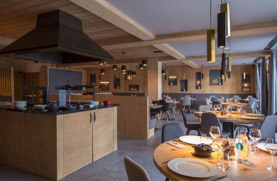 Open-concept dining area with central show kitchen and banquet seating