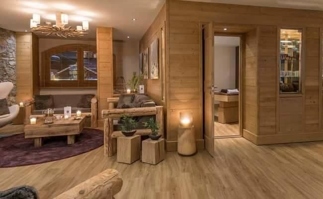 Spa lounge with log-style seating and private massage treatment room
