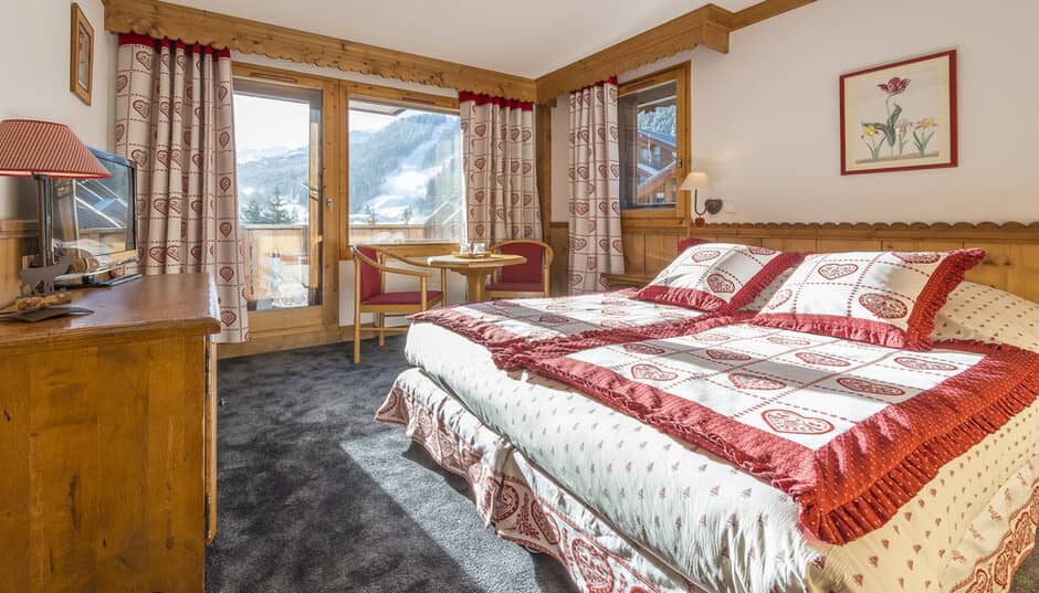Bedroom with mountain views and private balcony access