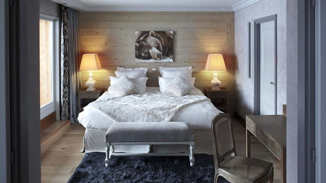 Guest bedroom with king bed, writing desk, and ensuite access