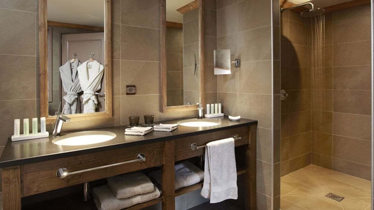 Bathroom with dual vanity and walk-in rainfall shower