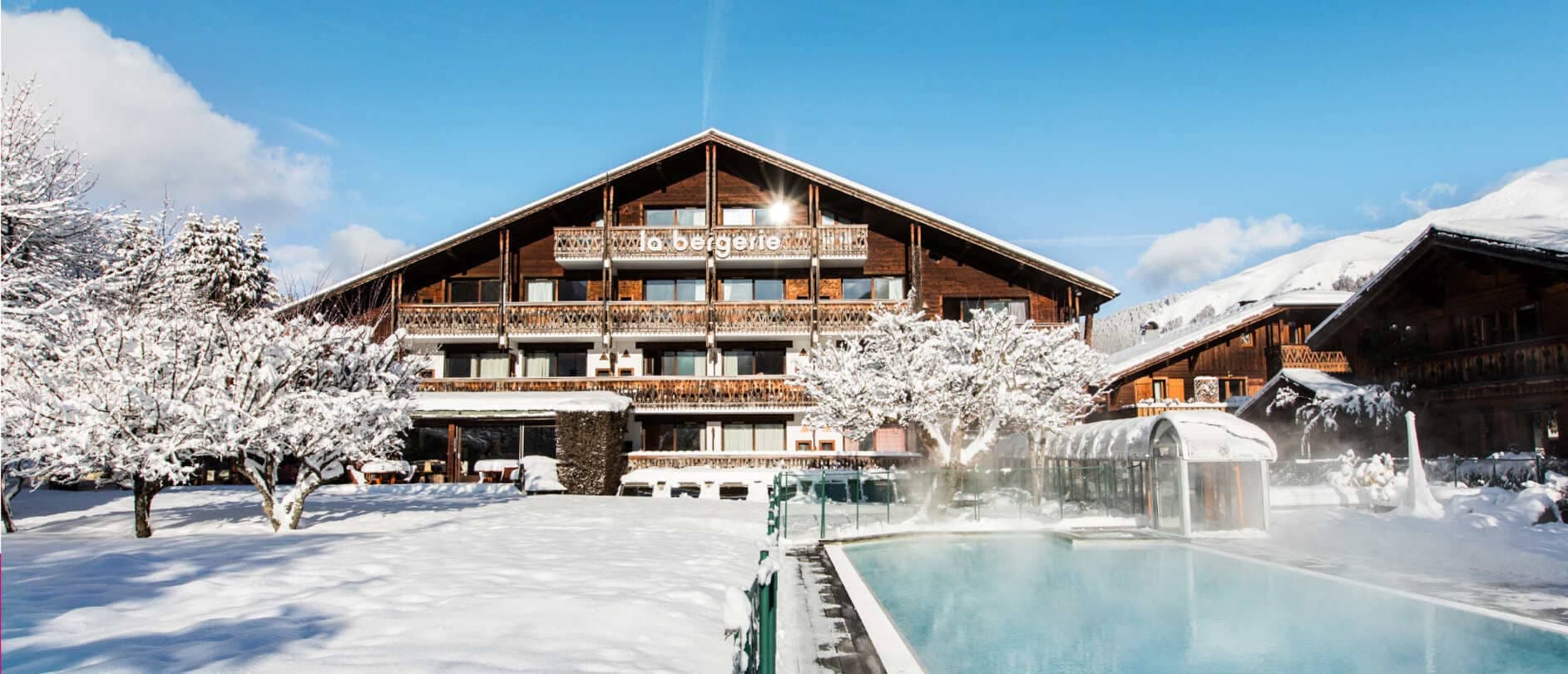 Chalet exterior with heated outdoor pool and private balconies