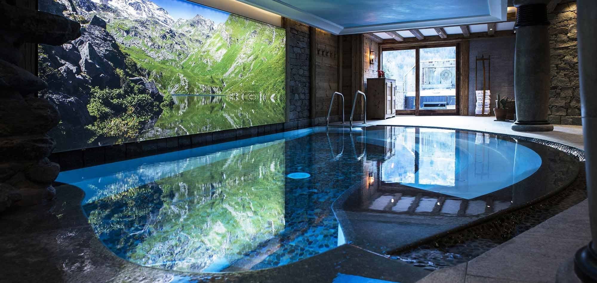 Indoor pool featuring mountain mural and glass doors to outdoor terrace