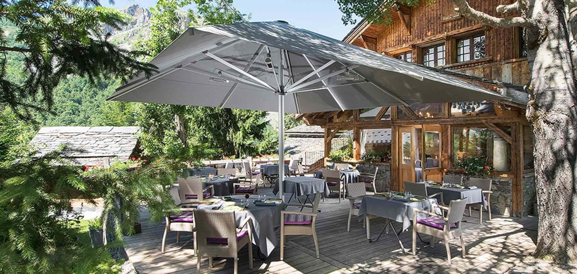 Outdoor dining terrace with heated umbrella and mountain views