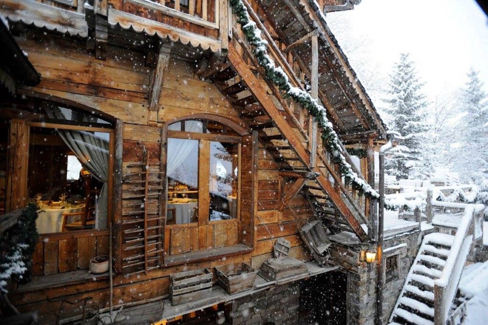 Chalet exterior with timber construction and stairs leading to upper level terrace