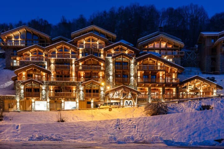 Ski-in/ski-out lodge exterior with private balconies and heated garage parking