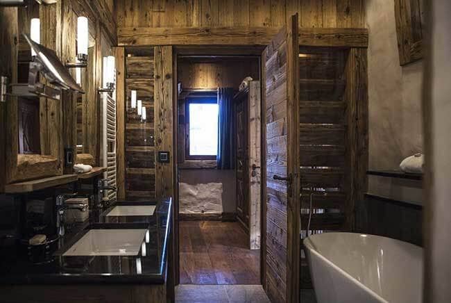 Bathroom with dual vanity, soaking tub, and heated towel rack