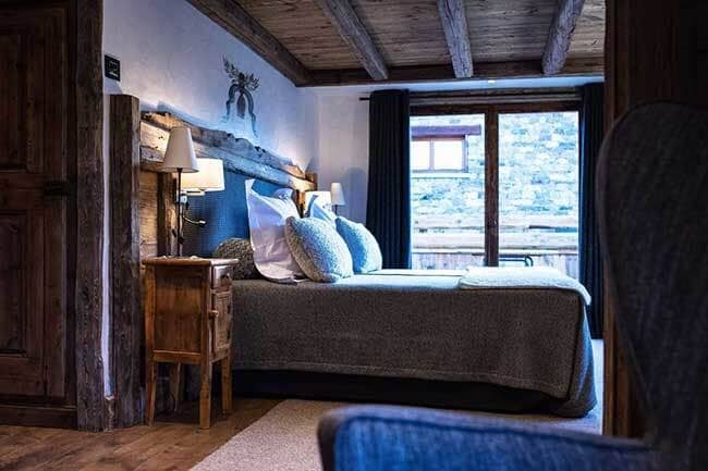 Bedroom with queen bed and reclaimed timber beam ceiling