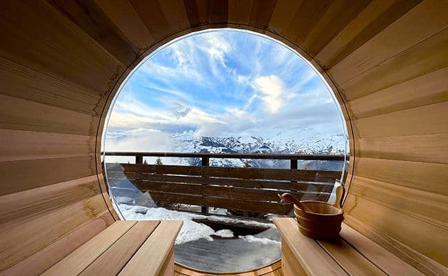 Cedar barrel sauna with bubble window and panoramic mountain views
