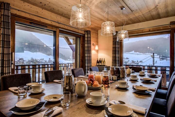 Dining area with seating for 10 and snowy mountain views