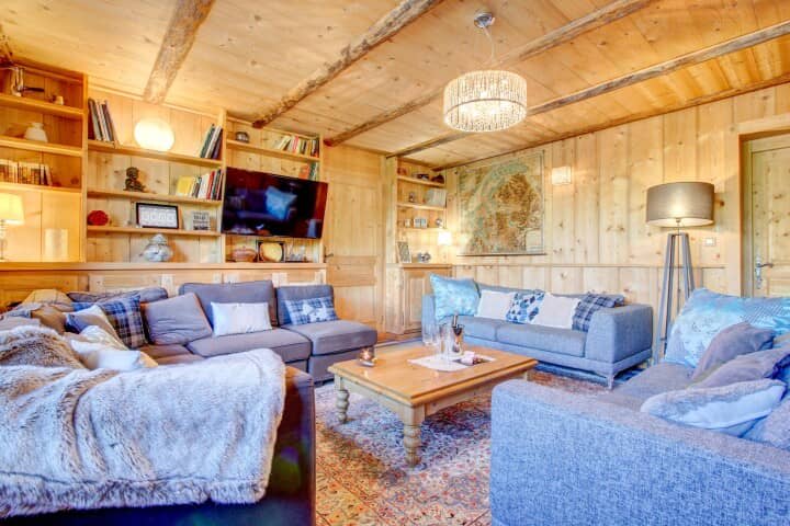 Living area with wood-paneled walls and seating for at least 10 adults