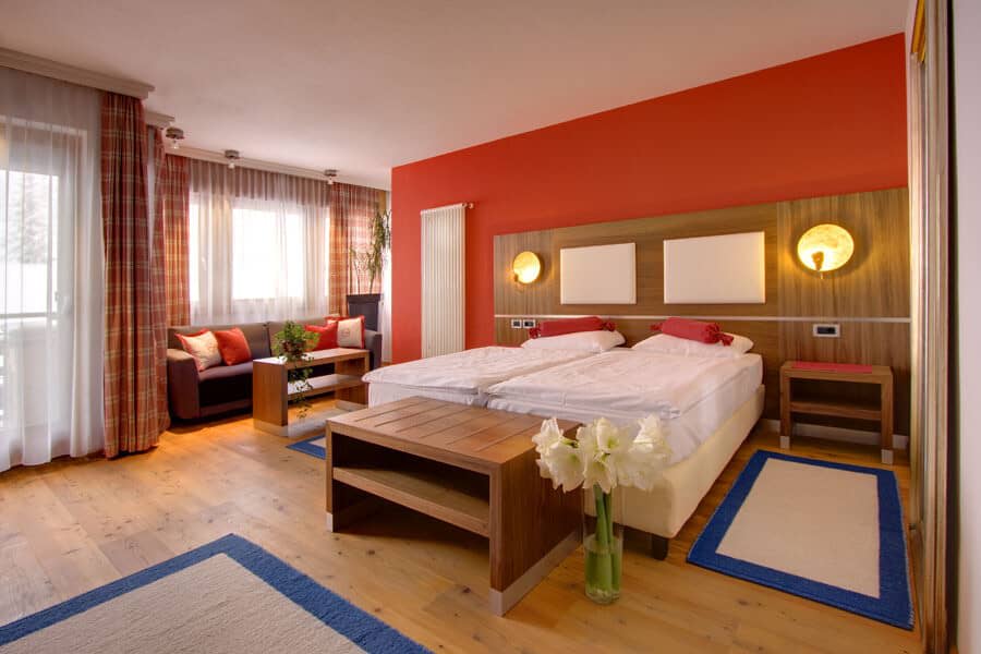 Guest suite with twin-configured king bed and separate sofa seating area