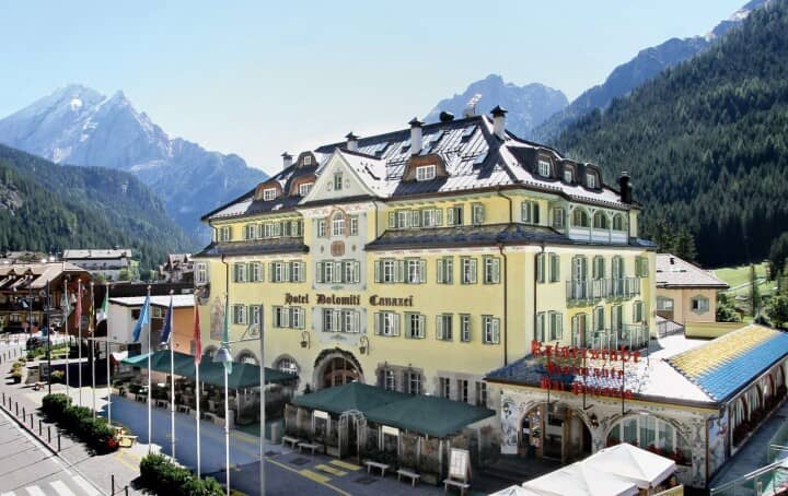 Hotel exterior with ground-floor restaurant and mountain views