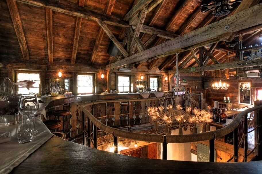 Mezzanine bar area with rope railing and exposed timber beams
