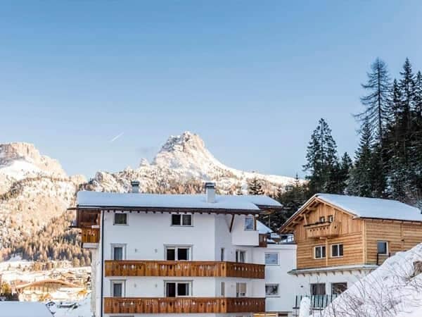Chalet exterior with private balconies and Dolomites mountain view