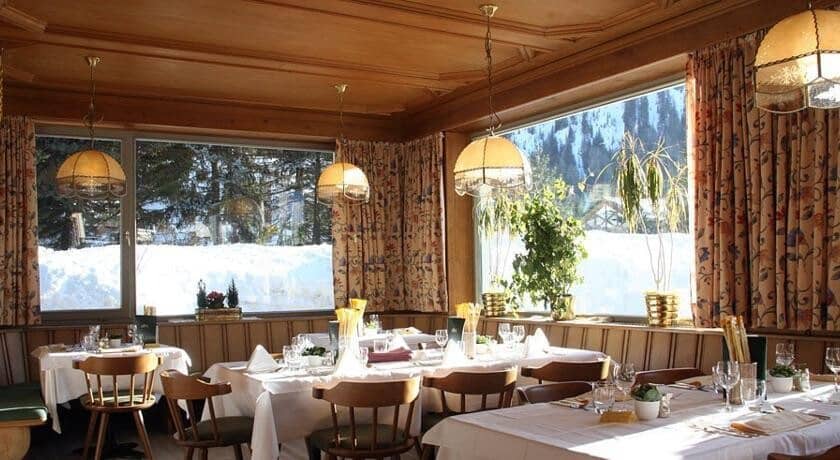 Dining area with booth seating and snow-covered mountain views