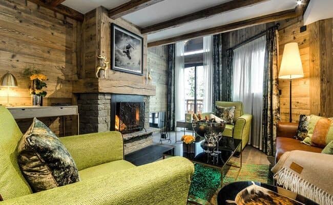 Living area with wood-burning fireplace and balcony access