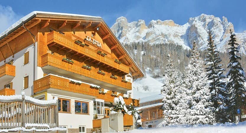 Chalet exterior with private balconies and direct Dolomite mountain views