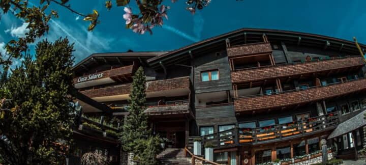 Chalet exterior featuring tiered private balconies and dark timber facade