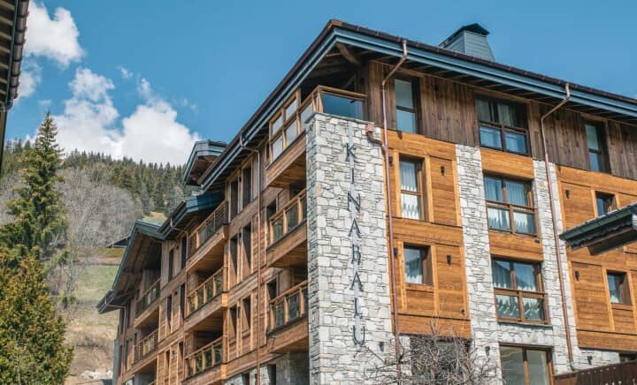 Kinabalu building exterior featuring private timber balconies and stone masonry