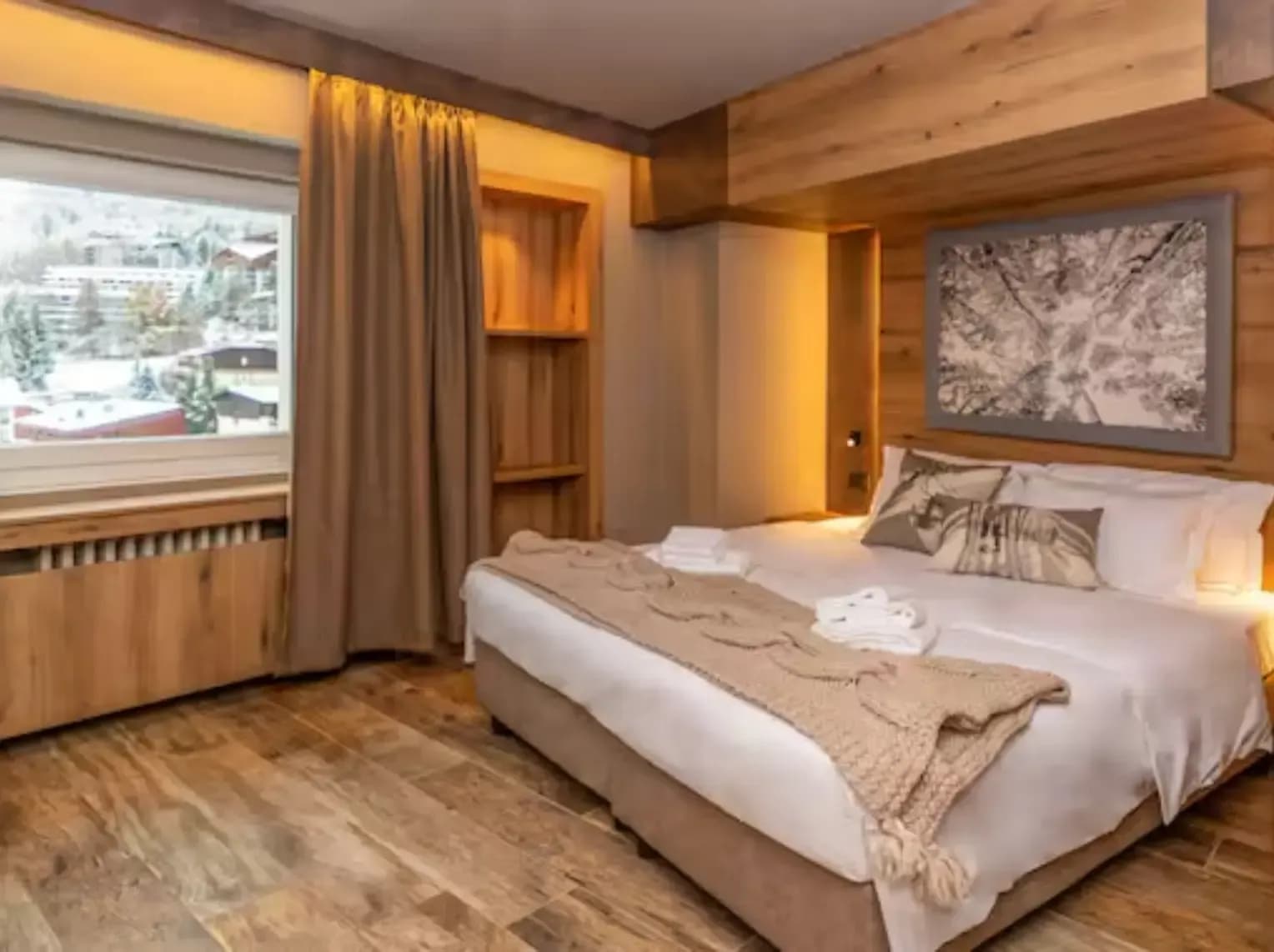 Primary bedroom with king bed and alpine village views