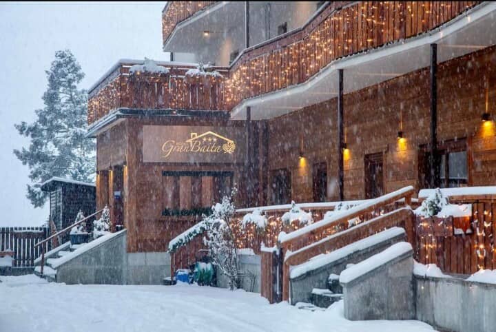 Chalet entrance with ramp access and decorative holiday lighting
