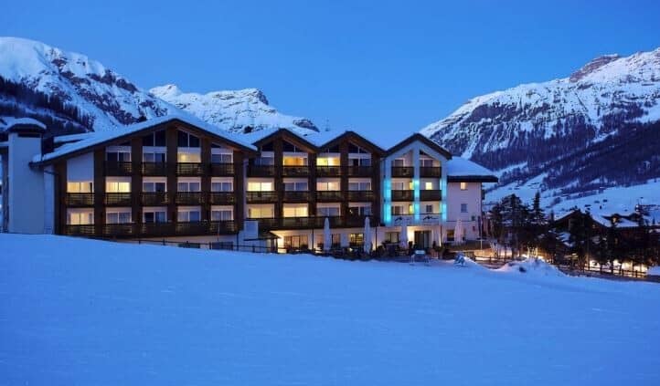 Ski-in, ski-out chalet exterior with private balconies and mountain backdrop