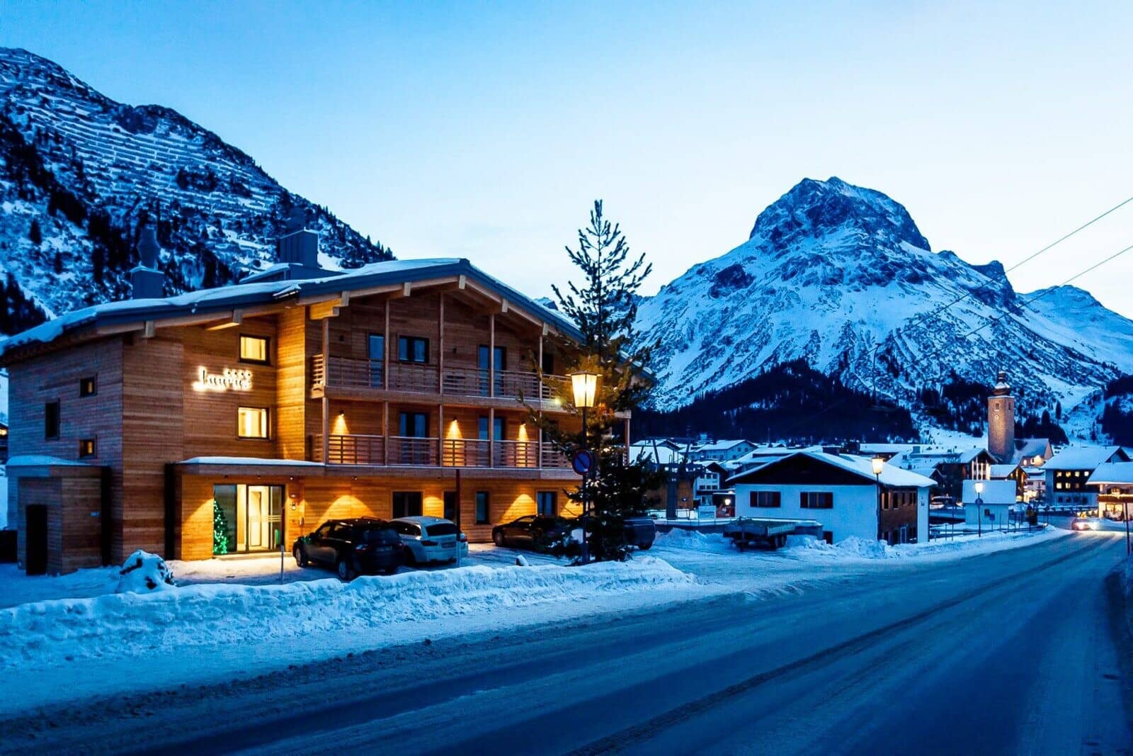 Chalet exterior with on-site parking and mountain views in Lech village