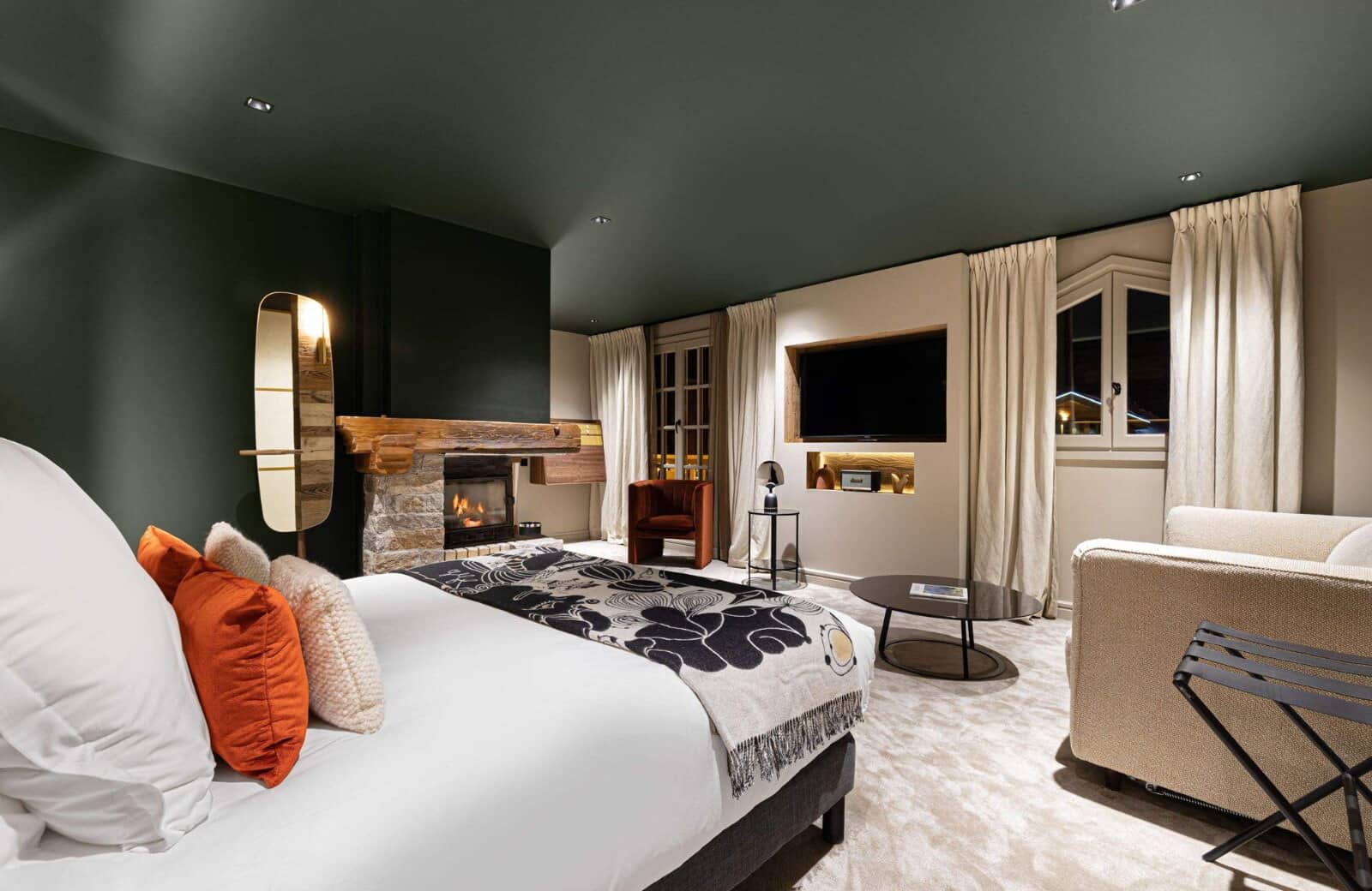 Primary bedroom with king bed, wood-burning fireplace, and lounge seating