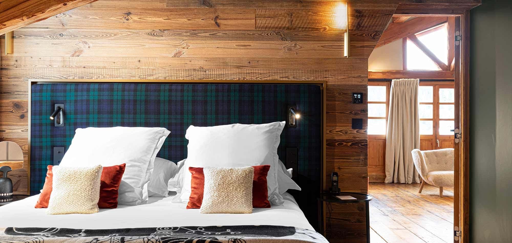 King bedroom with integrated reading lights and reclaimed wood paneling