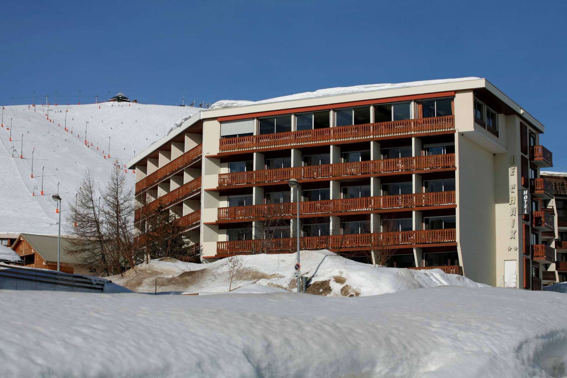 Ski-in/ski-out hotel exterior with private balconies and mountain views